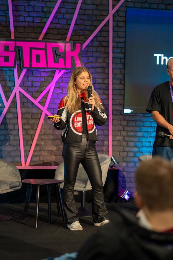 Eva speaking on stage at SaaStock